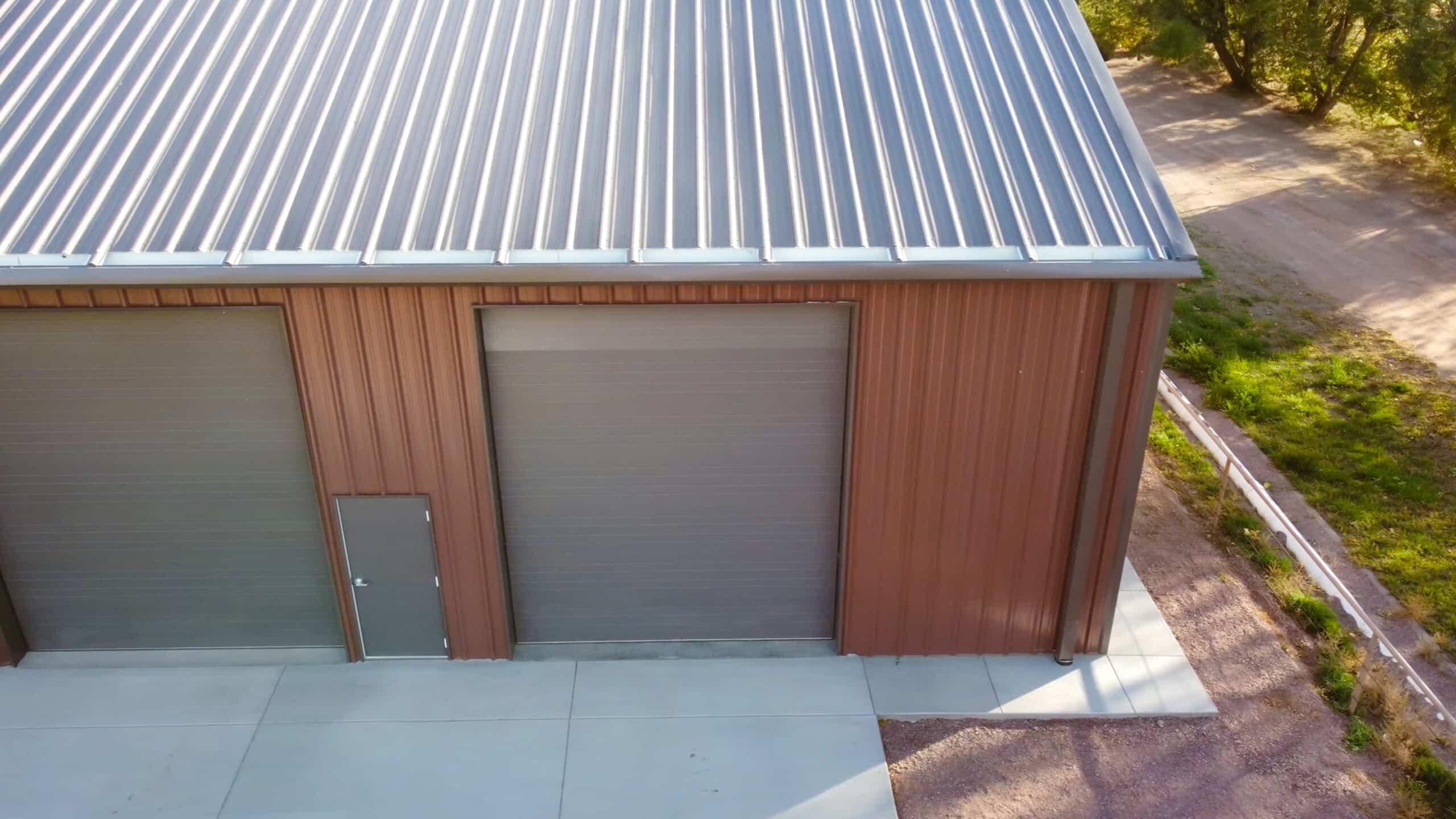 Large garage with red metal siding and silver metal roofing in Oak Creek CO scaled